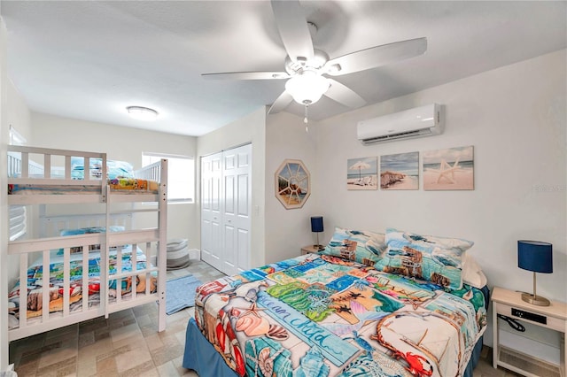 bedroom featuring ceiling fan, a closet, and a wall mounted AC