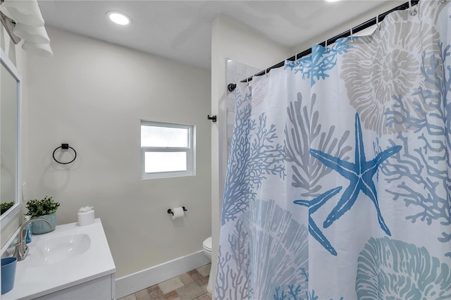 bathroom featuring vanity, toilet, and curtained shower