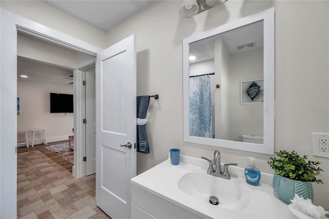 bathroom featuring vanity and toilet