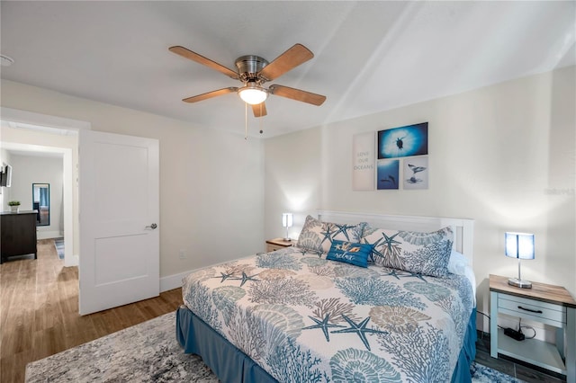 bedroom with wood-type flooring and ceiling fan