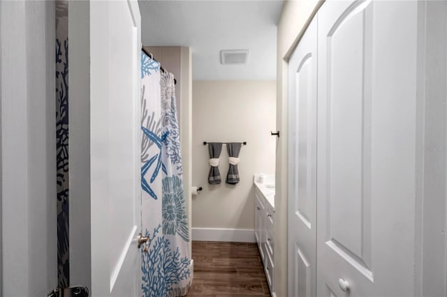 bathroom featuring vanity and wood-type flooring