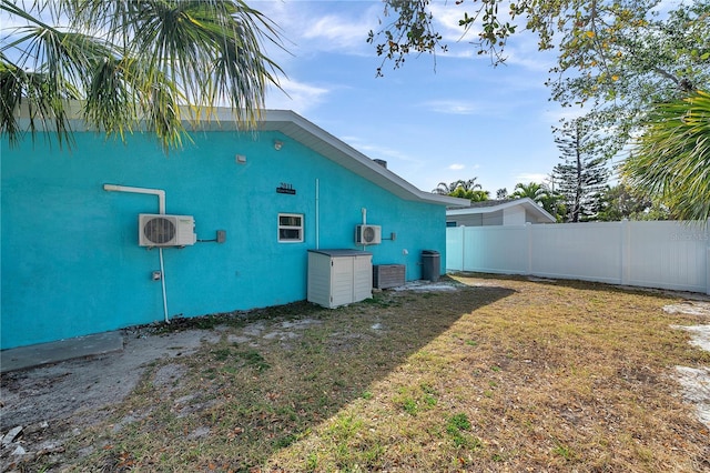 view of home's exterior featuring a yard and ac unit