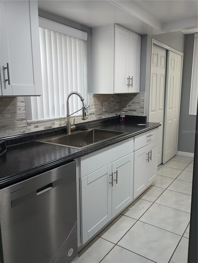 kitchen featuring dishwasher, sink, white cabinets, decorative backsplash, and light tile patterned floors