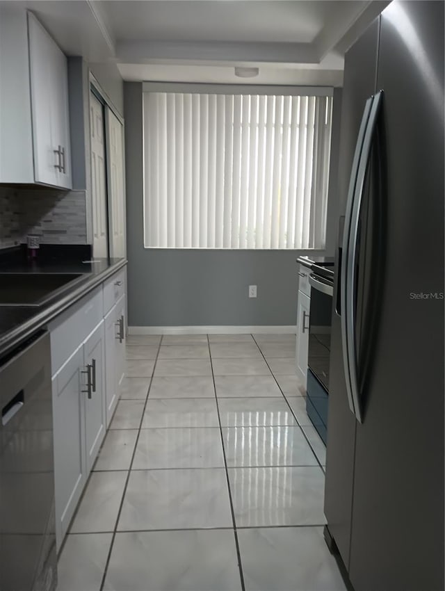 kitchen with stainless steel refrigerator with ice dispenser, electric range, dishwashing machine, white cabinets, and backsplash