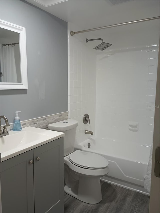 full bathroom featuring shower / tub combo with curtain, vanity, toilet, and wood-type flooring