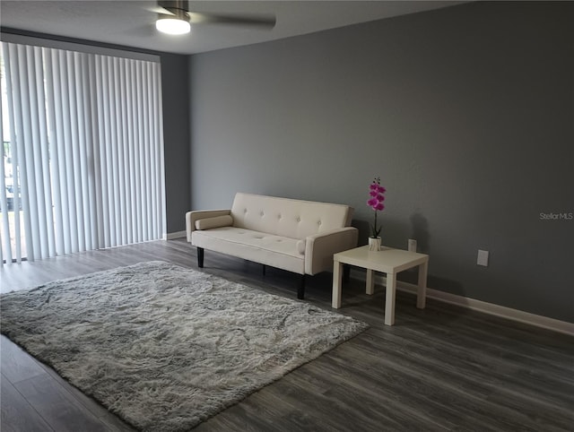 living room with dark hardwood / wood-style floors and ceiling fan