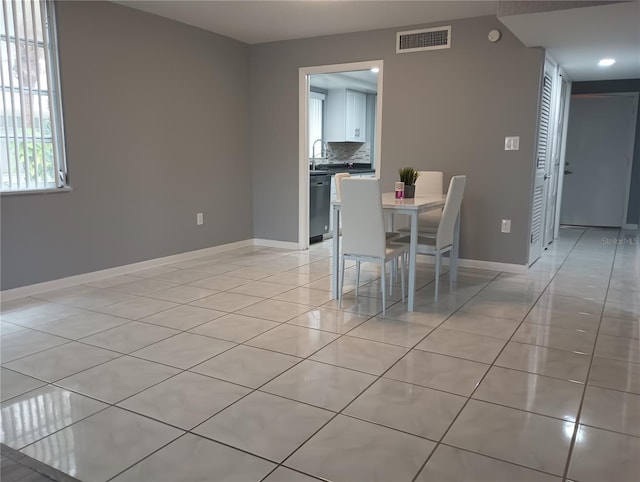 unfurnished dining area with sink and light tile patterned floors