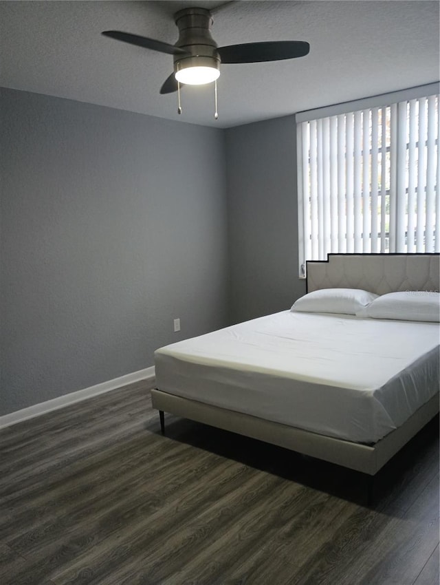 bedroom with dark wood-type flooring and ceiling fan