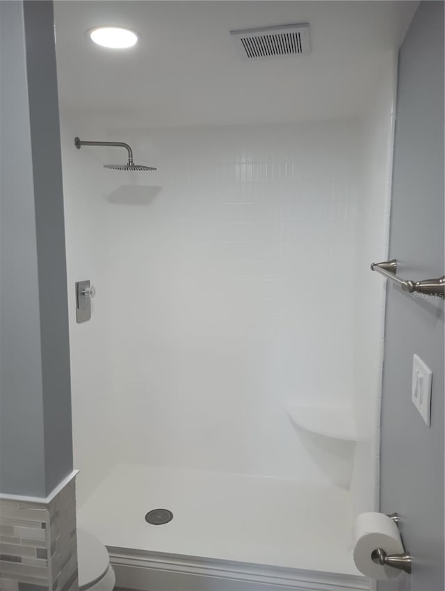 bathroom with toilet and a shower