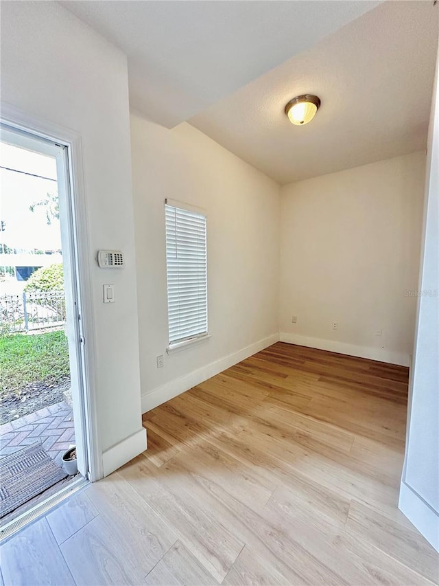 empty room with light hardwood / wood-style flooring