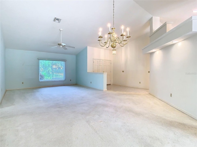 spare room with light carpet, ceiling fan with notable chandelier, and lofted ceiling