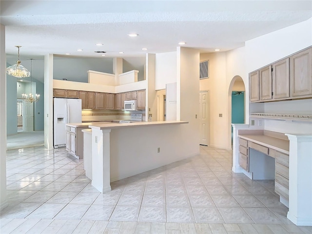 kitchen featuring high vaulted ceiling, white appliances, decorative light fixtures, and light tile patterned flooring