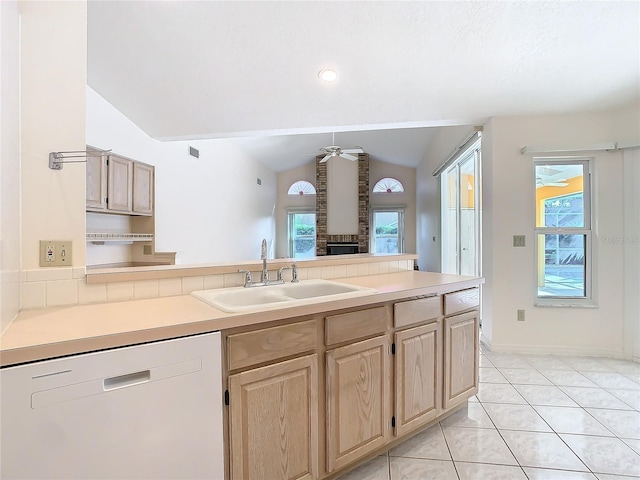 kitchen featuring lofted ceiling, sink, ceiling fan, white dishwasher, and light brown cabinetry