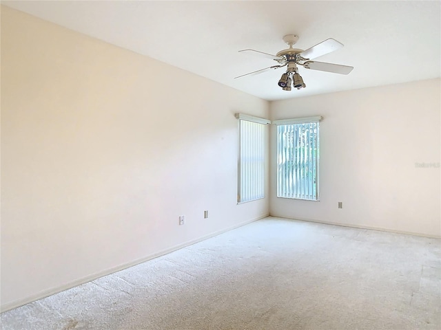 spare room with light carpet and ceiling fan