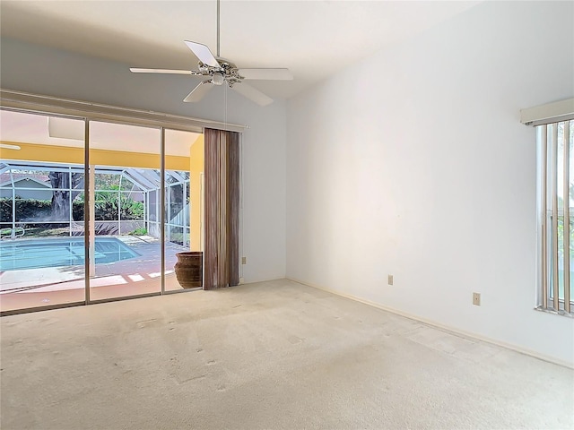 spare room with carpet floors and ceiling fan