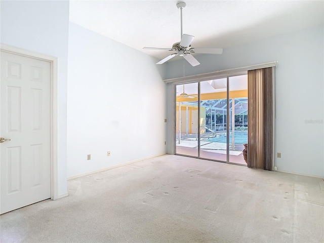 carpeted spare room featuring ceiling fan