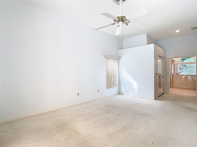 carpeted spare room with ceiling fan