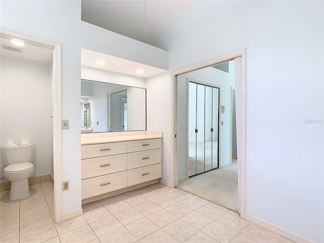 bathroom with vanity, tile patterned floors, and toilet