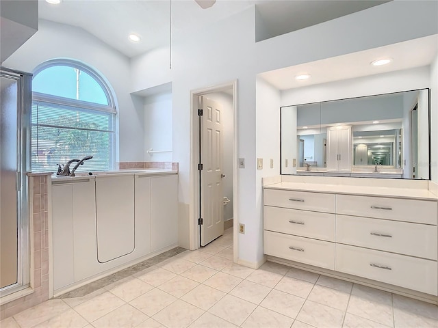 bathroom featuring vanity, an enclosed shower, tile patterned floors, and lofted ceiling