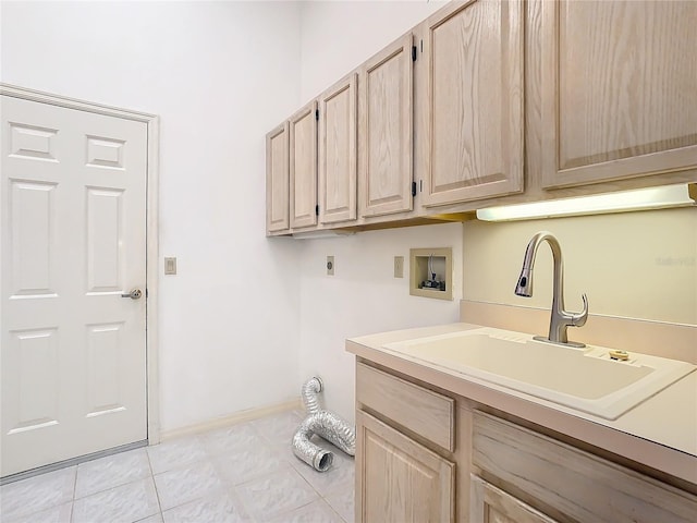 laundry room with sink, electric dryer hookup, hookup for a washing machine, cabinets, and light tile patterned flooring