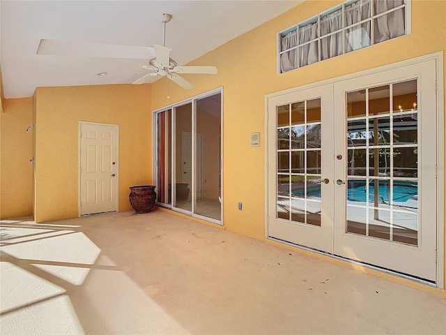 interior space with lofted ceiling, ceiling fan, and french doors