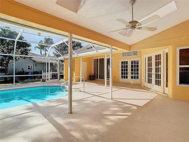 view of swimming pool featuring ceiling fan, glass enclosure, and a patio area