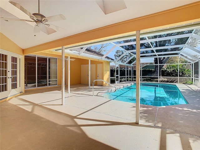 view of pool featuring ceiling fan, glass enclosure, and a patio area