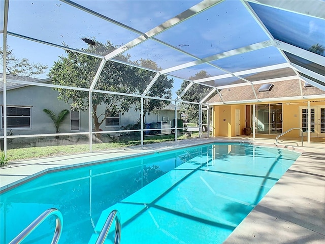 view of swimming pool with a lanai, a patio, and french doors