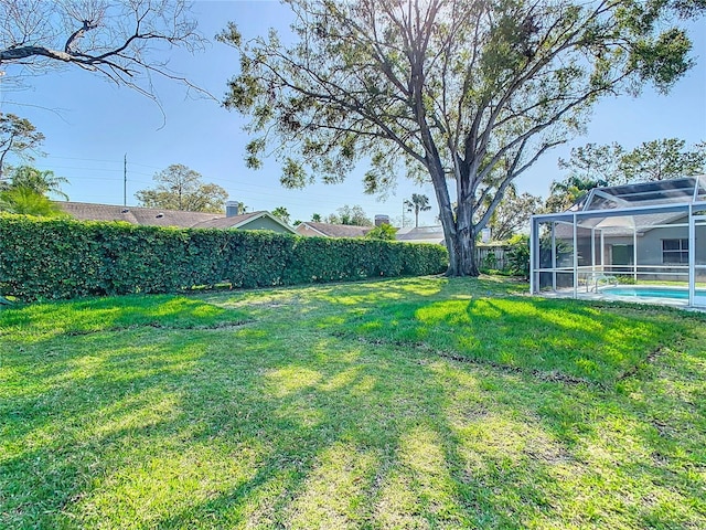 view of yard with a fenced in pool and a lanai