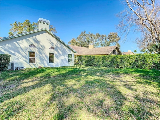 back of house with a lawn