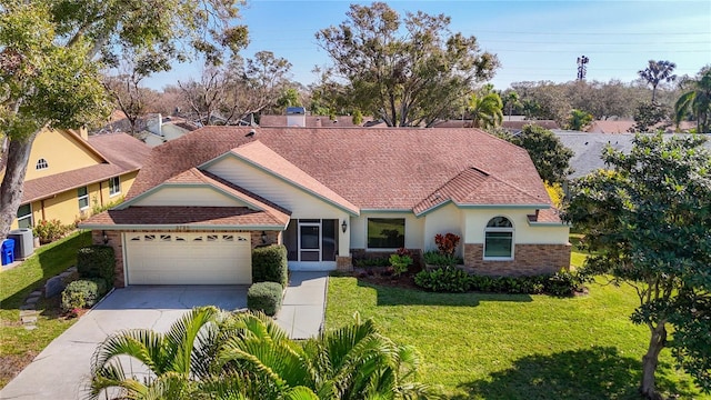 view of front of home with a garage and a front lawn