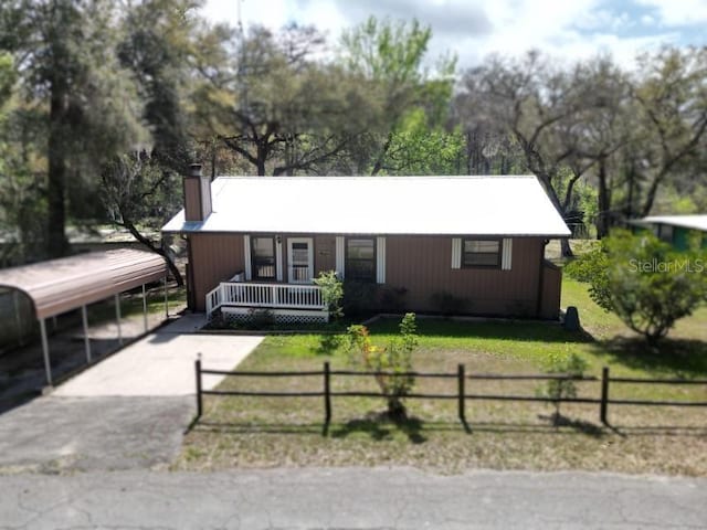 9461 Crk 657, Bushnell, FL 33513 - view of front of home with a front yard, covered porch, a fenced front yard, and a chimney