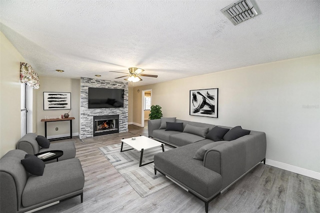 3013 Ridgevale Cir, Valrico, FL 33596 - living room featuring baseboards, a textured ceiling, a ceiling fan, visible vents, and wood finished floors