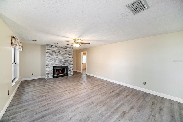 3013 Ridgevale Cir, Valrico, FL 33596 - unfurnished living room with visible vents, baseboards, a ceiling fan, a textured ceiling, and wood finished floors