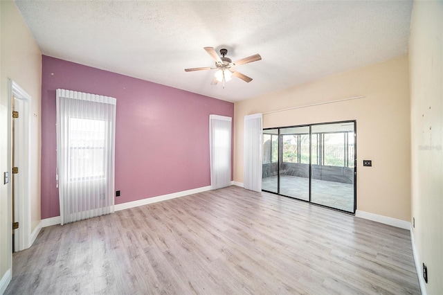 3013 Ridgevale Cir, Valrico, FL 33596 - unfurnished room with baseboards, a ceiling fan, wood finished floors, and a textured ceiling