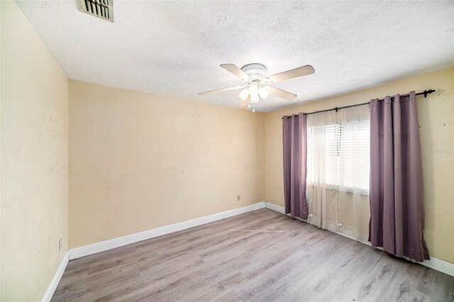 3013 Ridgevale Cir, Valrico, FL 33596 - empty room featuring visible vents, baseboards, ceiling fan, a textured ceiling, and wood finished floors
