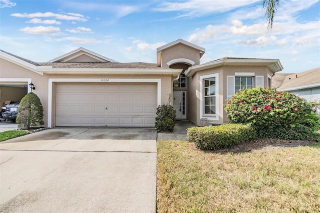 view of front of home featuring a garage and a front lawn