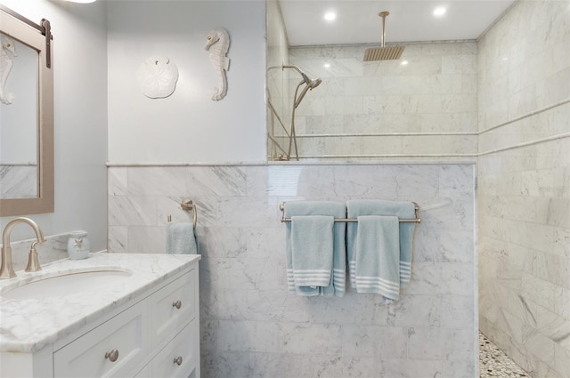 full bath featuring tile walls, vanity, recessed lighting, and walk in shower