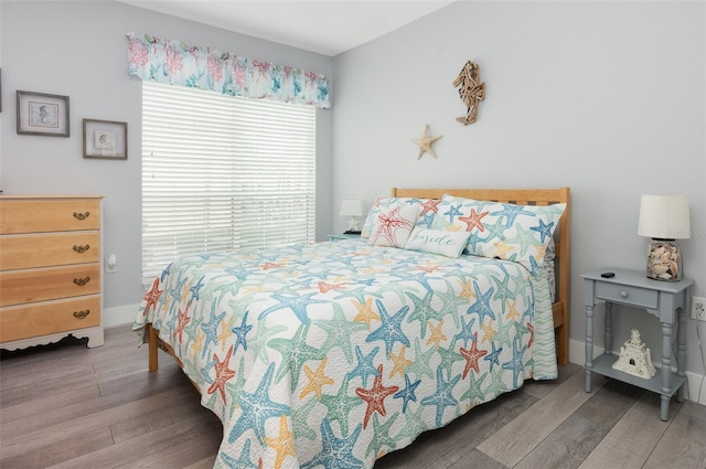 bedroom featuring baseboards and wood finished floors