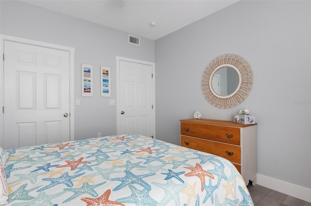 bedroom featuring visible vents and baseboards