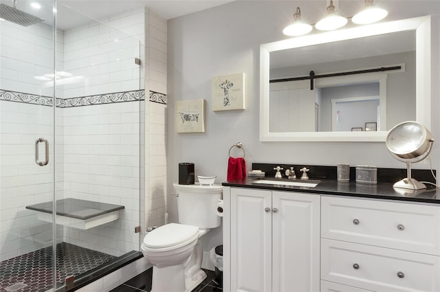 full bathroom featuring toilet, a stall shower, and vanity