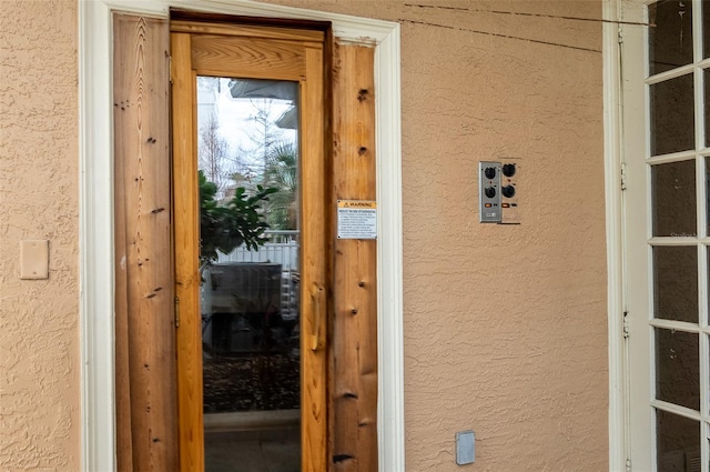 property entrance with stucco siding