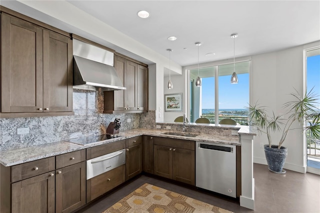 450 Knights Run Ave Unit 1704, Tampa, FL 33602 - kitchen featuring dishwasher, a warming drawer, wall chimney exhaust hood, black electric cooktop, and backsplash