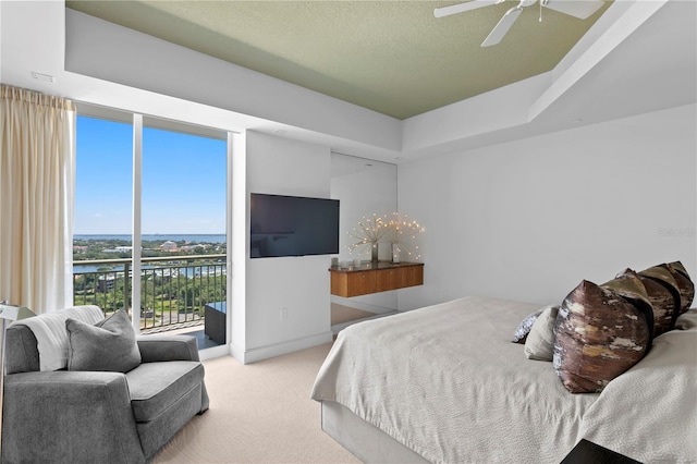 450 Knights Run Ave Unit 1704, Tampa, FL 33602 - bedroom with a tray ceiling, carpet, access to exterior, and a ceiling fan