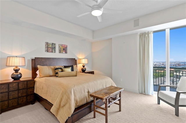 450 Knights Run Ave Unit 1704, Tampa, FL 33602 - bedroom featuring multiple windows, access to outside, light colored carpet, and a ceiling fan