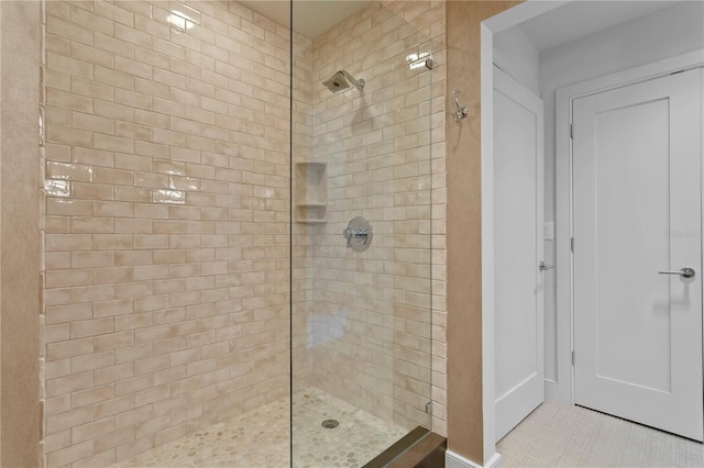 450 Knights Run Ave Unit 1704, Tampa, FL 33602 - bathroom featuring a tile shower and tile patterned floors