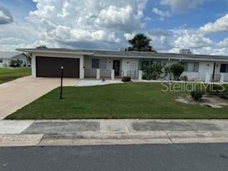 single story home with a garage and a front yard