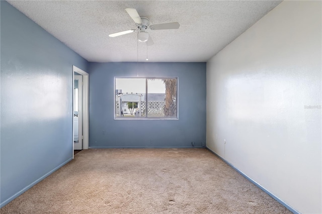 unfurnished room with a textured ceiling, carpet, and a ceiling fan