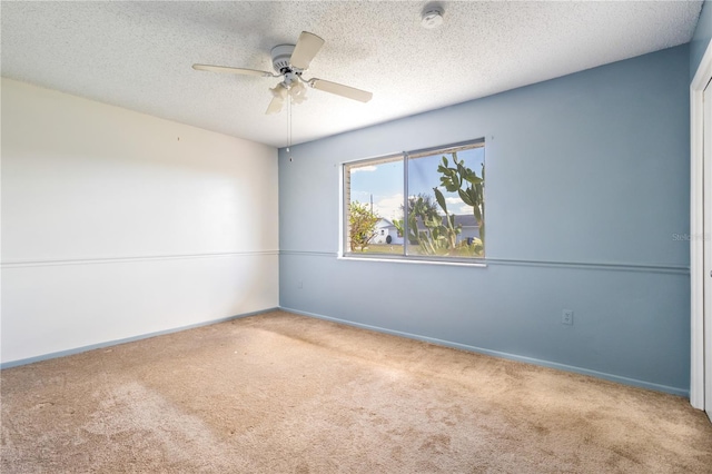 empty room with a ceiling fan, carpet, baseboards, and a textured ceiling