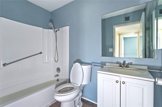 bathroom with visible vents, toilet, vanity, and shower / tub combination